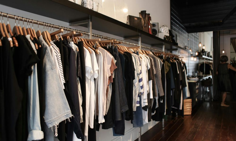 Explore trendy fashion displayed in an elegant boutique setting, showcasing diverse clothing styles.